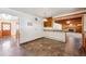 Open dining room with tiled floor and built-in bar area, next to the living room with fireplace at 209 S 13Th Ave, Brighton, CO 80601