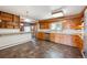 Functional kitchen with wood cabinets, a tile backsplash, and an adjacent dining space at 209 S 13Th Ave, Brighton, CO 80601