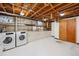Basement laundry room featuring a utility sink, cabinetry, and washer/dryer hookups at 209 S 13Th Ave, Brighton, CO 80601