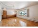 Living room featuring hardwood floors, a window, and an entry door at 209 S 13Th Ave, Brighton, CO 80601