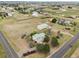 Aerial view of sprawling land with a home, barn, and various outbuildings in a rural setting at 4627 Cathy Ln, Erie, CO 80516