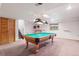Basement game room featuring a pool table with a distinctive motorcycle themed light fixture at 4627 Cathy Ln, Erie, CO 80516