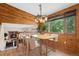 Dining area with light wood accents, large windows, and modern light fixtures at 4627 Cathy Ln, Erie, CO 80516