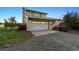 View of home highlighting the two-car garage and exterior stairway at 4627 Cathy Ln, Erie, CO 80516