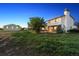 Home's exterior with a well-maintained lawn and additional outbuildings at 4627 Cathy Ln, Erie, CO 80516