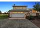 Two story home boasts an attached garage with a quaint wooden deck to the side at 4627 Cathy Ln, Erie, CO 80516