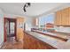 Quaint kitchen features custom wood cabinets, natural stone countertops, and a bright window view at 4627 Cathy Ln, Erie, CO 80516