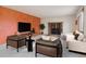Bright living room with modern decor, a stone fireplace, and large flat screen television at 4627 Cathy Ln, Erie, CO 80516