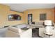 Inviting living room with comfortable seating, neutral tones, and seamless kitchen access at 4627 Cathy Ln, Erie, CO 80516