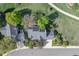Aerial view of a home with mature landscaping, solar panels, and a well-maintained lawn and fences at 902 Grove Dr, Louisville, CO 80027