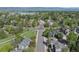 Aerial view of the neighborhood with beautiful landscaping, and serene views of the lake and mountains at 902 Grove Dr, Louisville, CO 80027