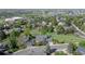 Aerial view of the home in a neighborhood with mature trees and green lawns at 902 Grove Dr, Louisville, CO 80027