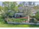 An aerial view of home with a green lawn and a deck with outdoor seating at 902 Grove Dr, Louisville, CO 80027