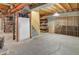 Unfinished basement with a wine rack, storage shelves, and a stairway at 902 Grove Dr, Louisville, CO 80027