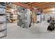 Spacious basement with exposed wood beams, concrete floor, shelving, and storage space at 902 Grove Dr, Louisville, CO 80027
