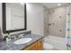 Updated bathroom featuring a granite countertop, tiled shower and bathtub at 902 Grove Dr, Louisville, CO 80027