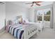 Cozy bedroom with twin beds, colorful accents, and a large window at 902 Grove Dr, Louisville, CO 80027