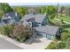 An elevated view of a home with a gray roof, two-car garage and mature landscaping around the property at 902 Grove Dr, Louisville, CO 80027