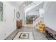 Bright foyer with tiled flooring, staircase, contemporary lighting, and decorative accents at 902 Grove Dr, Louisville, CO 80027