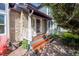 Inviting front entrance with stone accents, a charming porch, and wooden steps leading to the door at 902 Grove Dr, Louisville, CO 80027