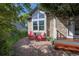 Inviting stone patio with two red Adirondack chairs and a small table at 902 Grove Dr, Louisville, CO 80027