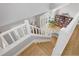Staircase overlooking a well-lit interior with a bookshelf and hardwood floors at 902 Grove Dr, Louisville, CO 80027