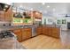 Spacious kitchen with wooden cabinets, granite countertops, stainless steel appliances, and hardwood floors at 902 Grove Dr, Louisville, CO 80027