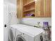Functional laundry room with a washer, dryer, built-in shelving, and storage space at 902 Grove Dr, Louisville, CO 80027