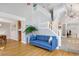 Open living room with hardwood flooring, a staircase, and access to the dining and work areas at 902 Grove Dr, Louisville, CO 80027