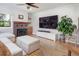 Comfortable living room with hardwood floors, a fireplace, and a large-screen television at 902 Grove Dr, Louisville, CO 80027