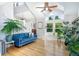 Bright living room with hardwood floors, vaulted ceilings, and large windows showcasing the view at 902 Grove Dr, Louisville, CO 80027
