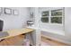 Bright office space with hardwood floors, a modern desk, and a large window providing natural light at 902 Grove Dr, Louisville, CO 80027