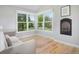 Cozy sunroom with hardwood floors, a fireplace, and large windows overlooking the backyard at 902 Grove Dr, Louisville, CO 80027