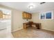 Finished basement featuring tile flooring, a desk, and a utility room with a washer and dryer at 10311 E Evans Ave # 133, Aurora, CO 80247
