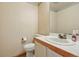 Half-bathroom with white tiling, wood trim, and decorative wallpaper at 10311 E Evans Ave # 133, Aurora, CO 80247