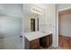 Bathroom features a large mirror, vanity with sink, and doorway leading to another room at 10311 E Evans Ave # 133, Aurora, CO 80247