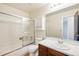Bathroom featuring a glass shower, white tiling and a dark wood vanity at 10311 E Evans Ave # 133, Aurora, CO 80247