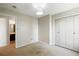 Neutral bedroom features carpet, standard closet with white doors, and an ensuite bathroom entrance at 10311 E Evans Ave # 133, Aurora, CO 80247