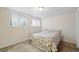 Bedroom featuring carpet, a floral bedspread and bright, natural light at 10311 E Evans Ave # 133, Aurora, CO 80247
