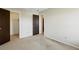 Clean, carpeted bedroom with neutral walls, featuring two doors leading to other parts of the home at 10311 E Evans Ave # 133, Aurora, CO 80247