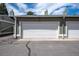 Two-car garage with white doors and house number. Perfect for parking and storage at 10311 E Evans Ave # 133, Aurora, CO 80247