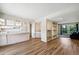 Bright living room with wood floors, a kitchen, and an open layout at 10311 E Evans Ave # 133, Aurora, CO 80247