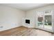 Living room with wood floors, a fireplace, and a door to the yard at 10311 E Evans Ave # 133, Aurora, CO 80247