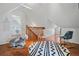 Upstairs loft featuring a rocking horse, chair, and access to another room at 1429 Josephine St, Denver, CO 80206