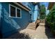 Sideyard with wooden deck and staircase leading to the back entrance at 1429 Josephine St, Denver, CO 80206