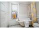 Bright bathroom featuring a vintage clawfoot tub, patterned shower curtain, and charming stained glass window at 1429 Josephine St, Denver, CO 80206
