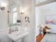 Bathroom featuring classic fixtures, wainscoting, decorative lighting, and a view into bedroom at 1429 Josephine St, Denver, CO 80206