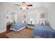Comfortable bedroom with two twin beds, neutral walls, hardwood floor and sitting nook at 1429 Josephine St, Denver, CO 80206
