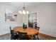 Inviting dining room boasts a wooden table, stylish lighting, and seamless view into kitchen at 1429 Josephine St, Denver, CO 80206