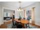 Charming dining room features an oval table, black chairs and decor, and view to living room at 1429 Josephine St, Denver, CO 80206
